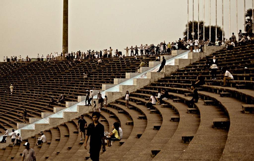 Aérobic et footing dans le stade olympique de Phnom Penh à la tombée de la nuit